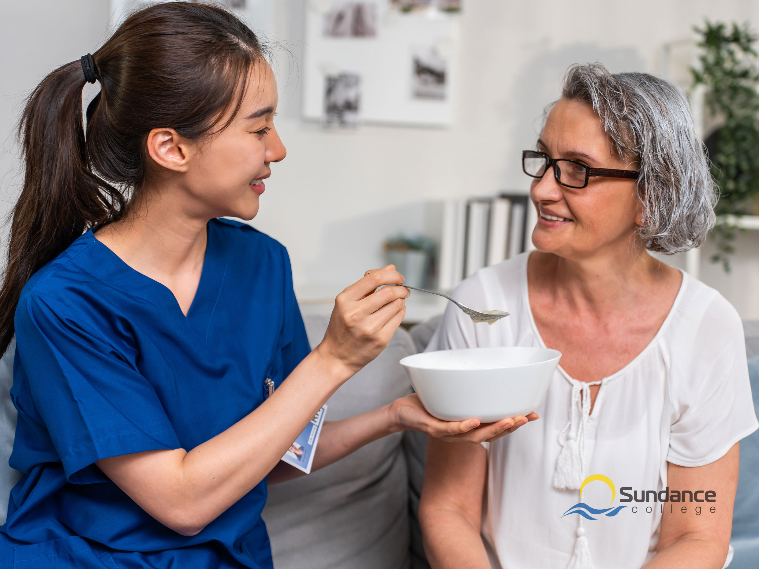 A personal support worker feeding patient at a group home