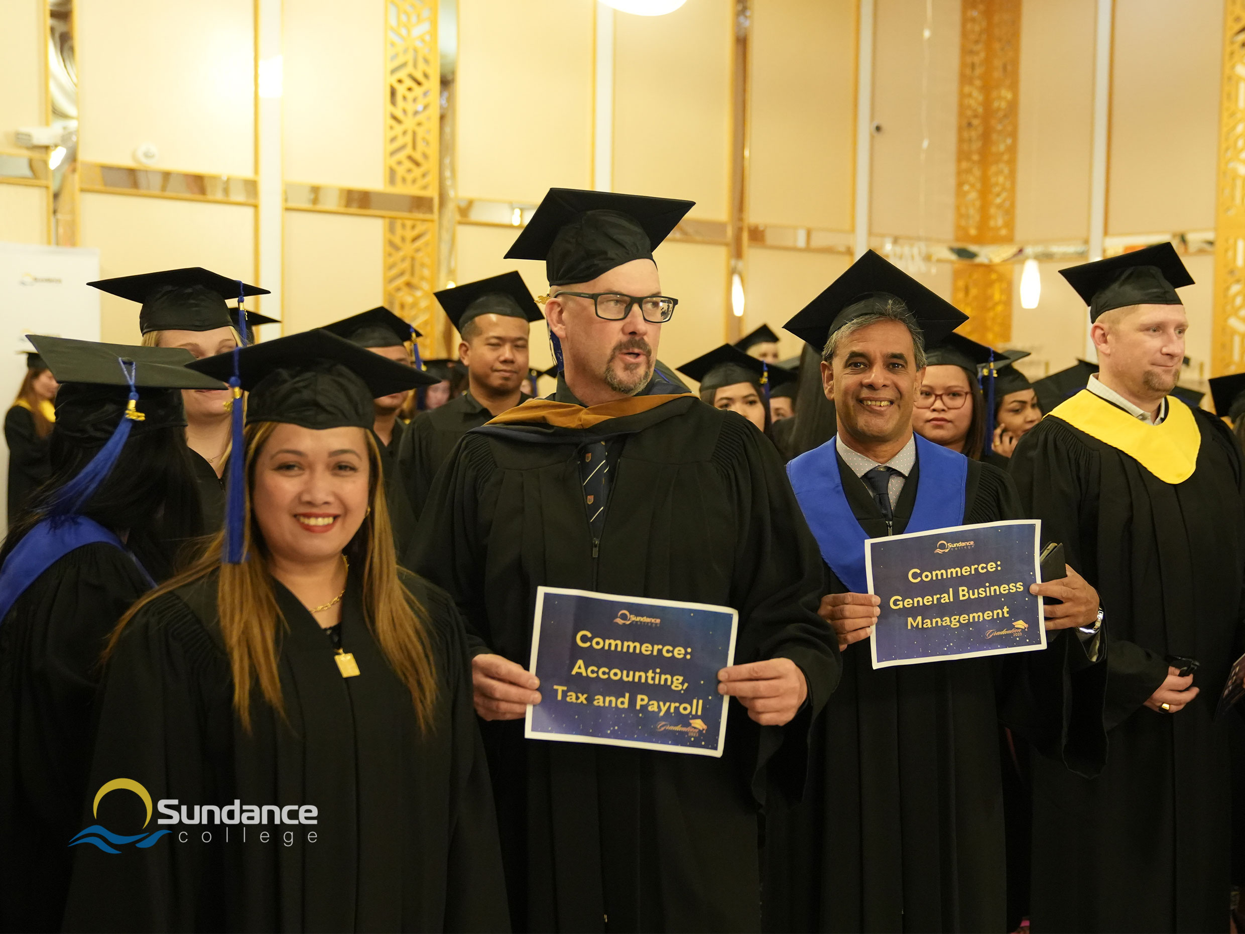 Smiling graduates from the General Business Diploma Program and Accounting, Tax, and Payroll Diploma program with their instructors at Sundance College Graduation Ceremony in Calgary 2023.