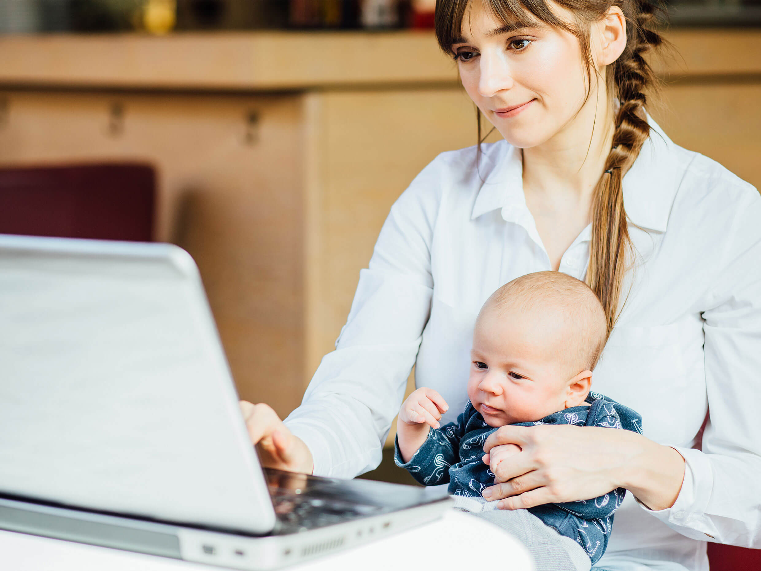 Online student attending online course at home with her son