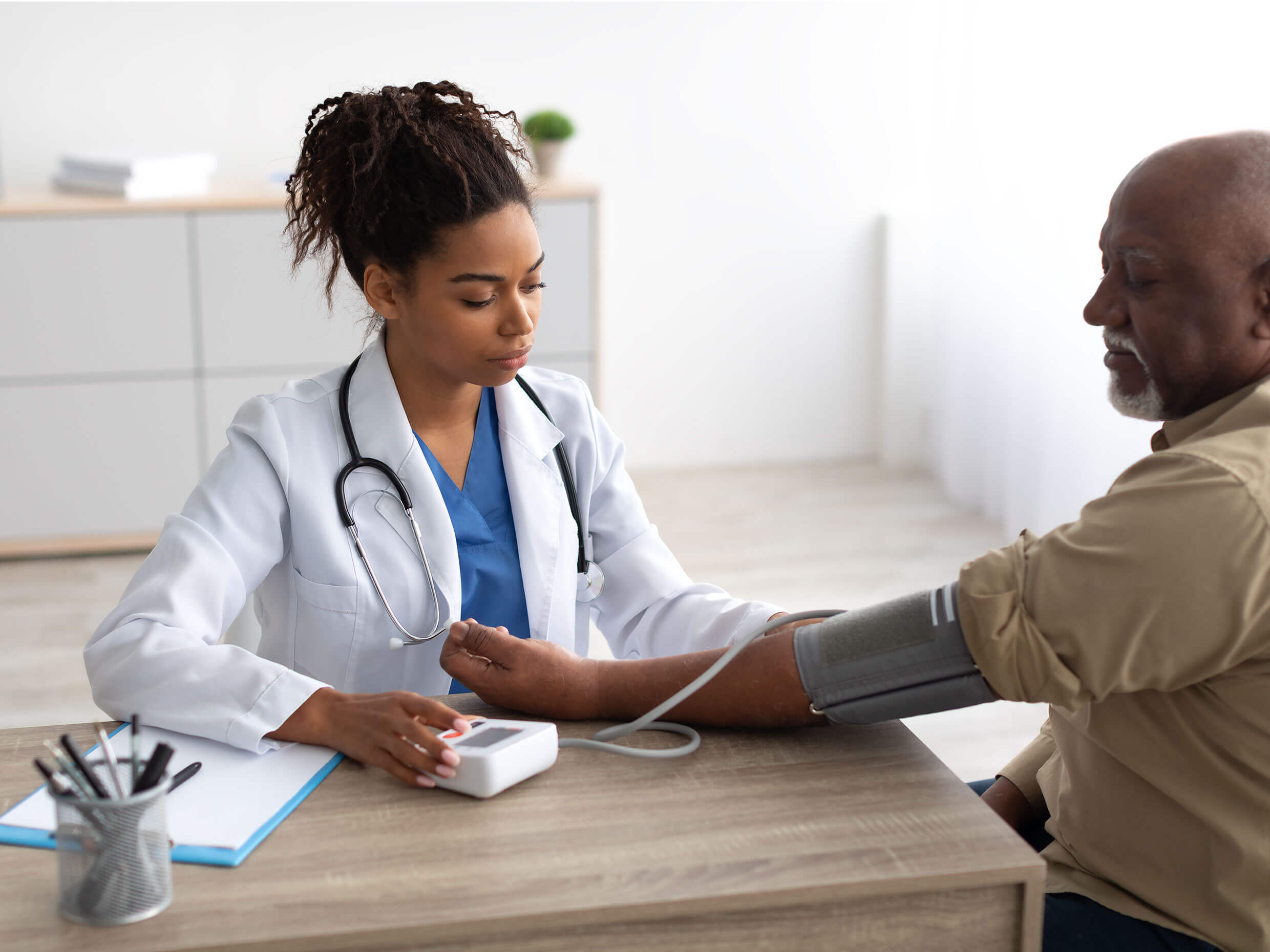 medical office administrator gathering billing information from a patient in a medical setting