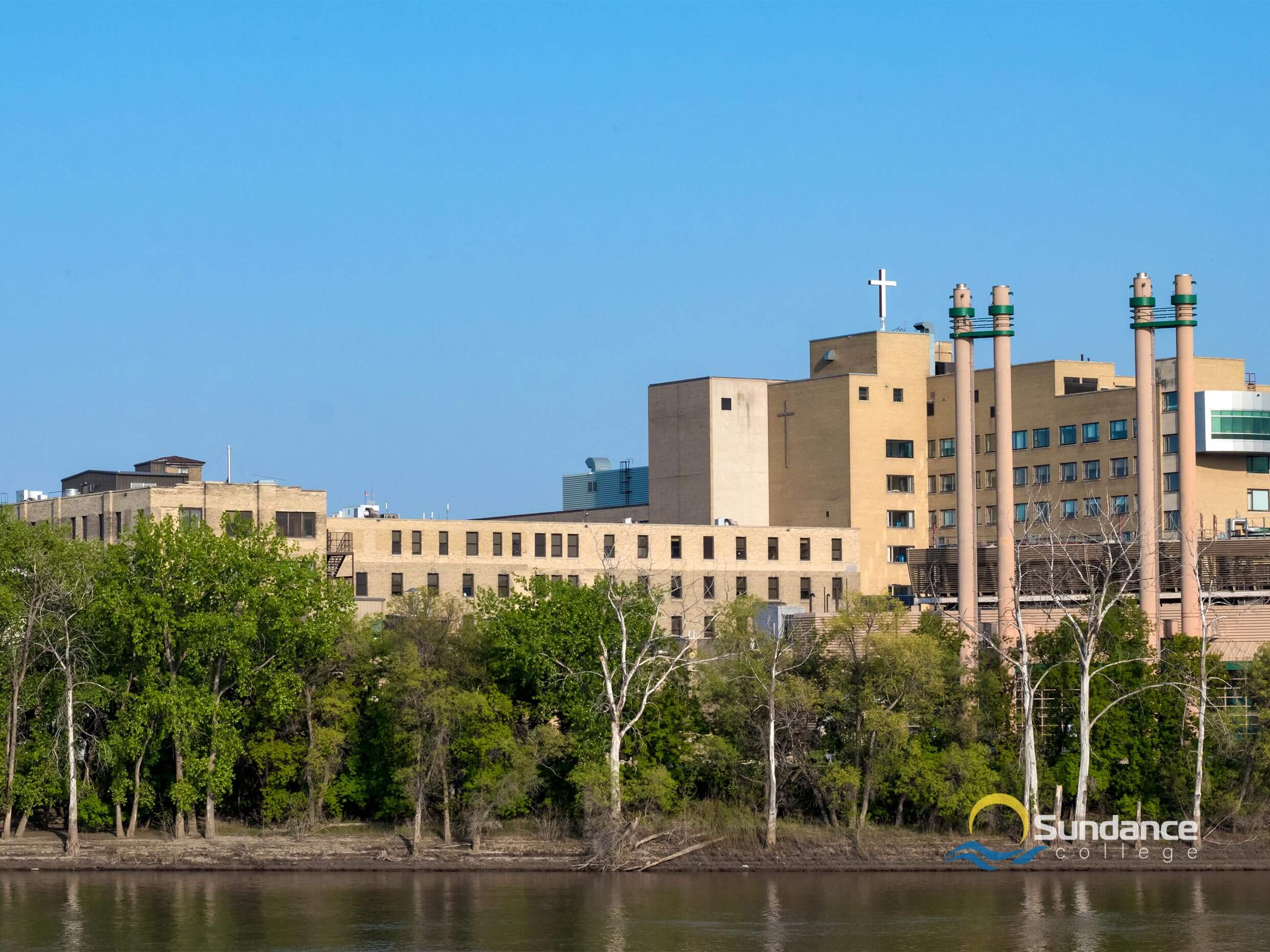 View of the St. Boniface Hospital across the Red River where pharmacists require the help of pharmacy assistant diploma graduates in the hospital pharmacy