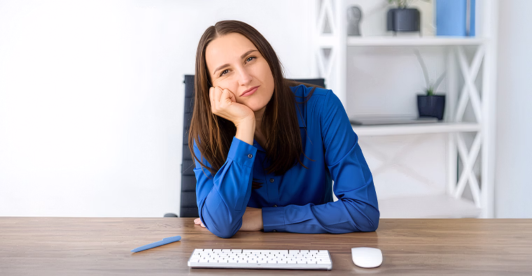 A woman sits at her desk wondering if she needs a career change in 2026