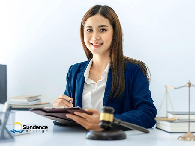 A professional woman taking notes on what key skills for legal assistants are needed for success in the legal field.