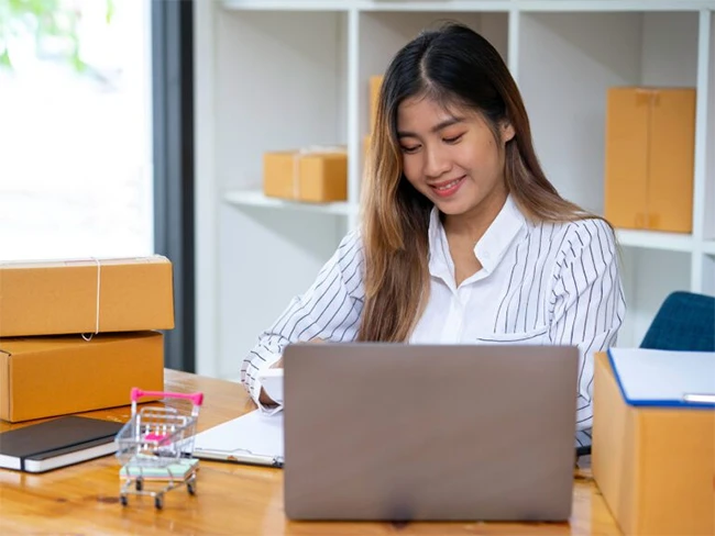 Supply Chain Management professional sitting in front of her laptop.
