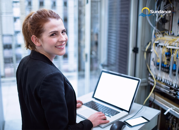 A Network Systems Manager troubleshoots network hardware on her laptop.