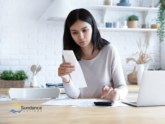 Young woman calculates monthly expenses