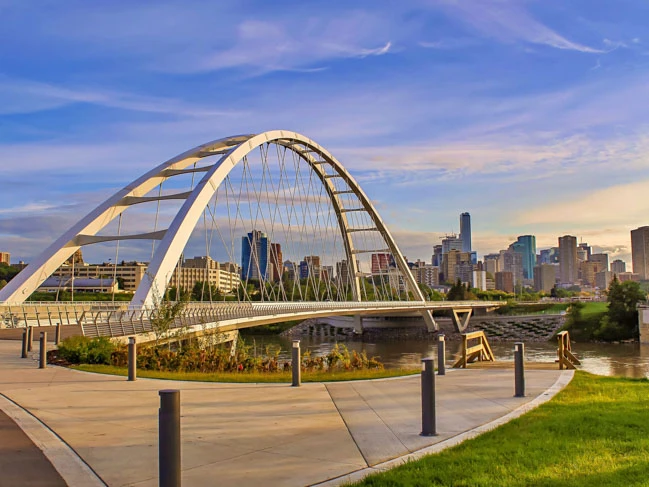 a bridge over a river with a city in the background Edmonton walterdale bridge