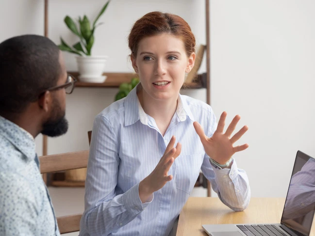 a woman talking to a man hr manager training