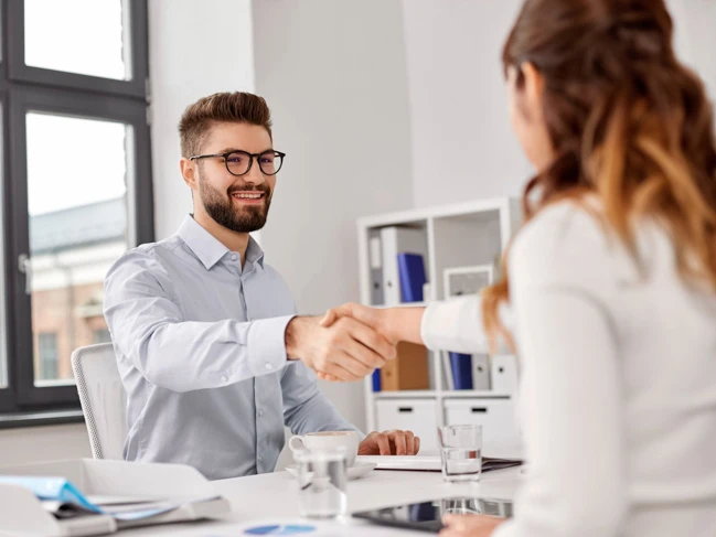 a man and woman shaking hands employers