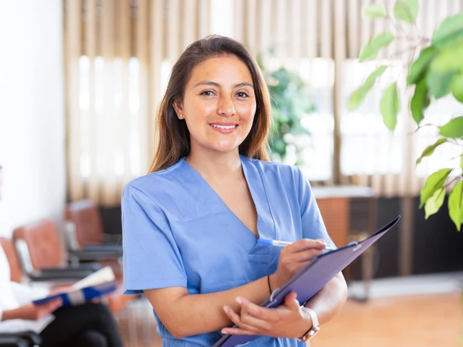 a woman in a blue shirt holding a clipboard