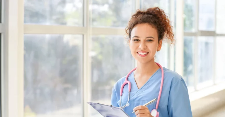 a woman in blue scrubs holding a clipboard and pen career change online college diploma