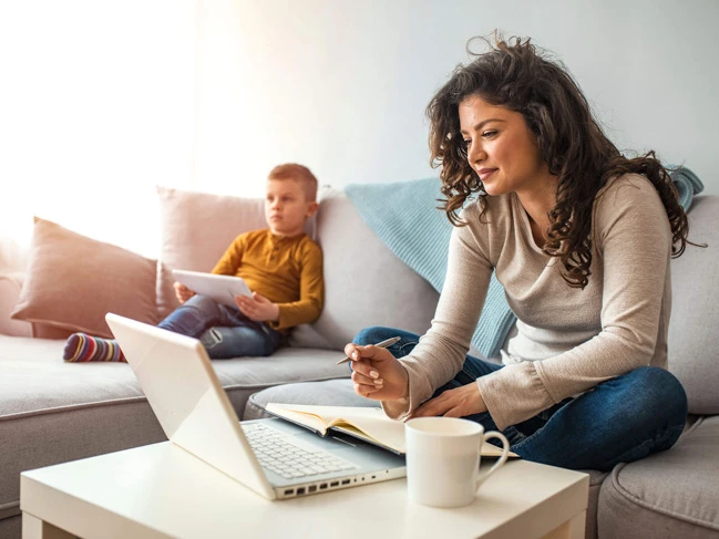 a woman and boy sitting on a couch