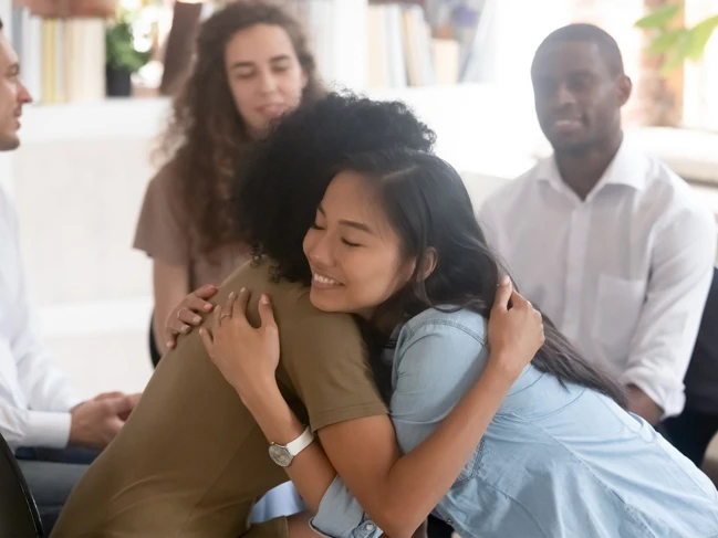 Outreach worker supporting her client during a group session.