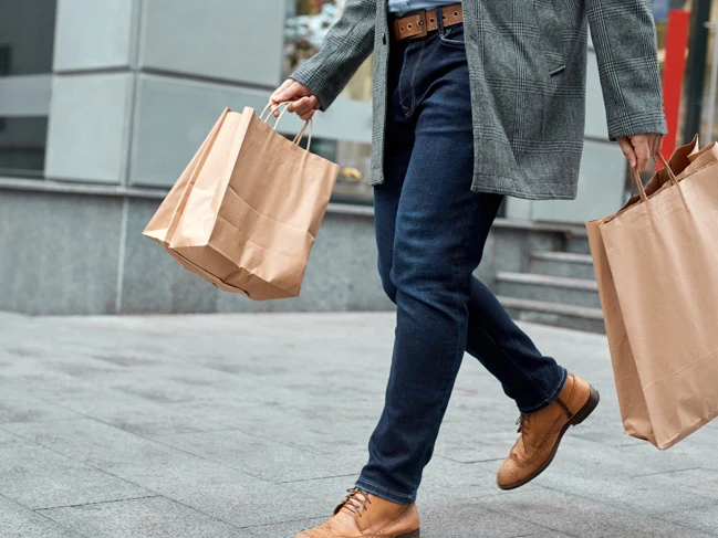 a person walking with a bag shopping bags 