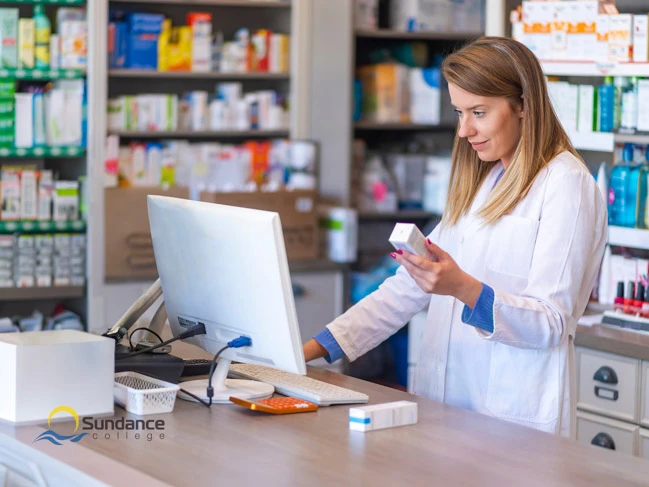 Pharmacy assistant verifying medicine for patients.