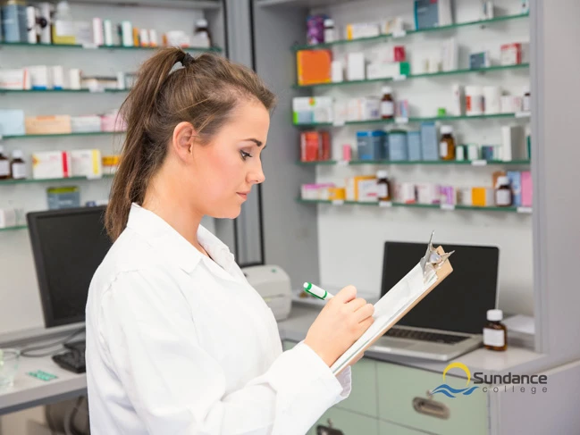 Pharmacy assistant writing a note for patient.