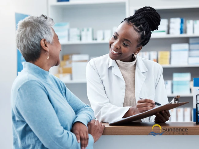 Pharmacy assistant helping a patient