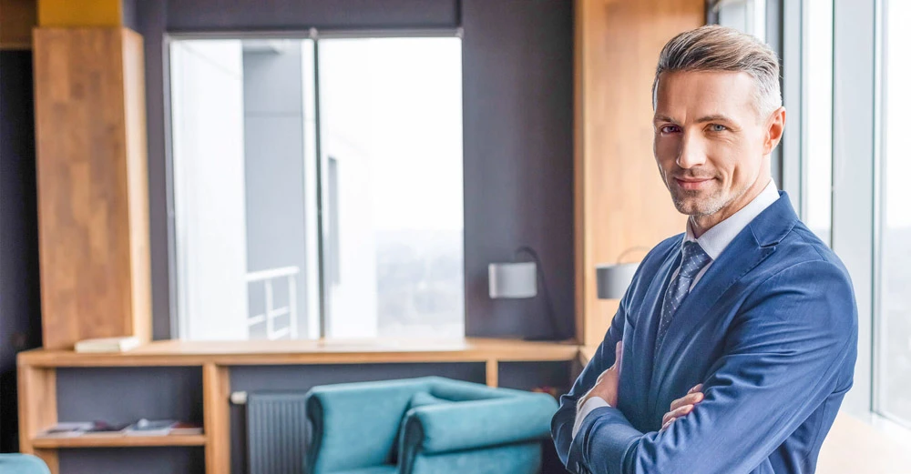 Hospitality Business Management man standing in an office