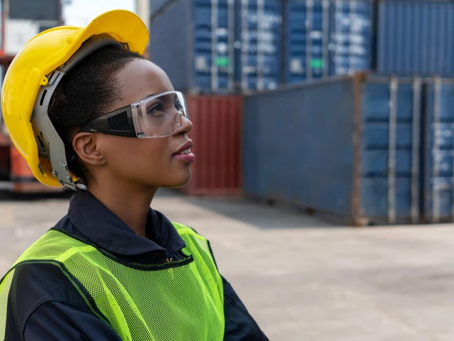 a woman wearing a hard hat and safety vest supply chain management