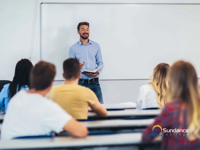 Young Students listening to professor in classroom college student