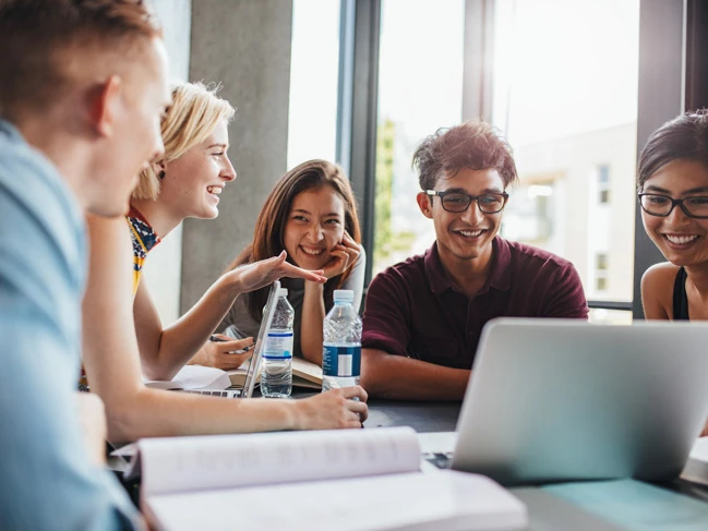 a group of people sitting around a table resolutions career college students