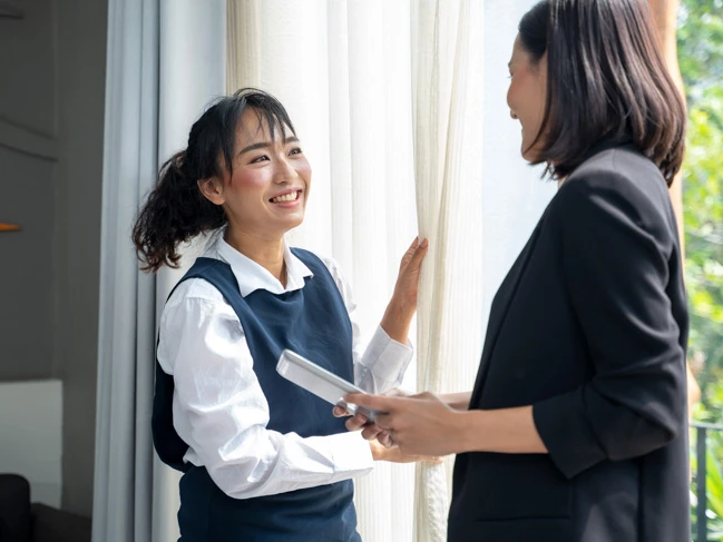 hotel manager and staff talking in hotel room