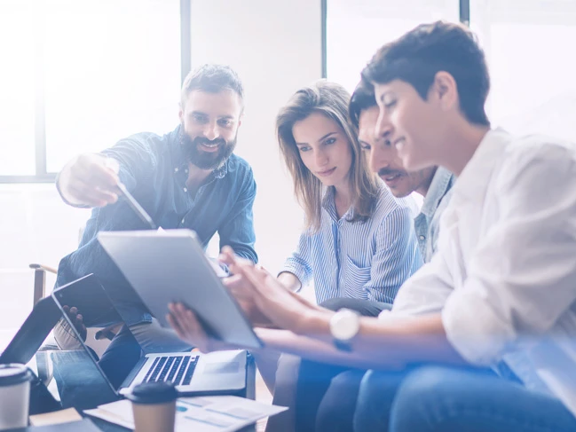 a group of people looking at a tablet