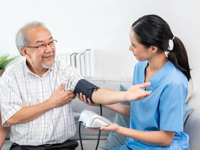 a nurse measuring a man's blood pressure