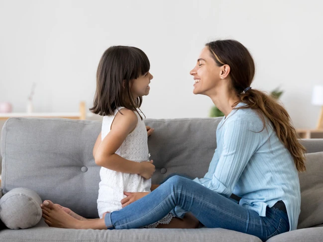 mother and girl child talking