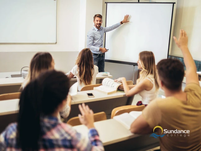 Smiling teacher standing in front of the class