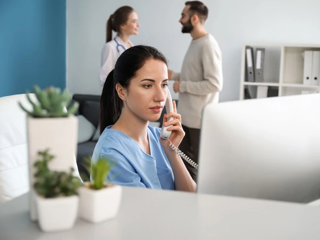 a woman on the phone medical office administration