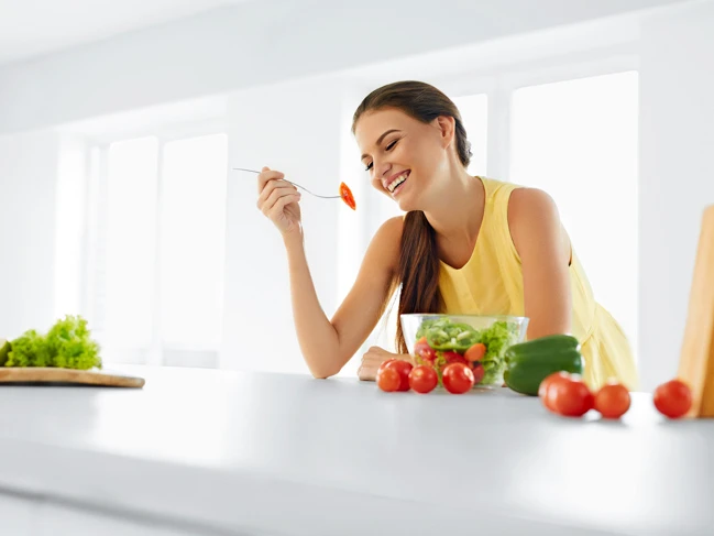 a woman eating a salad