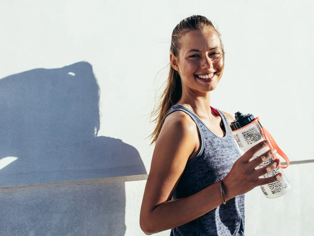 a woman holding a water bottle