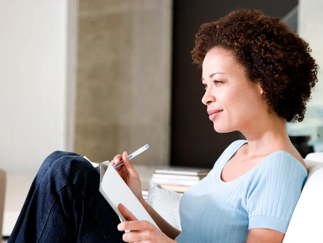 a woman writing in a notebook