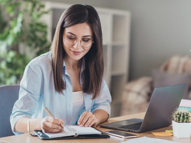 a woman writing in a notebook