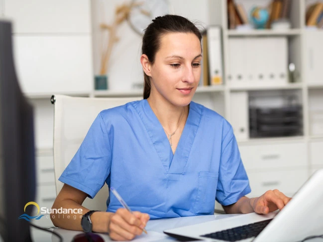 Young female makes notes in hospital