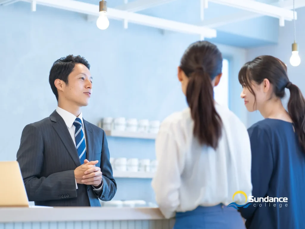 hospitality manager is guiding two female customers