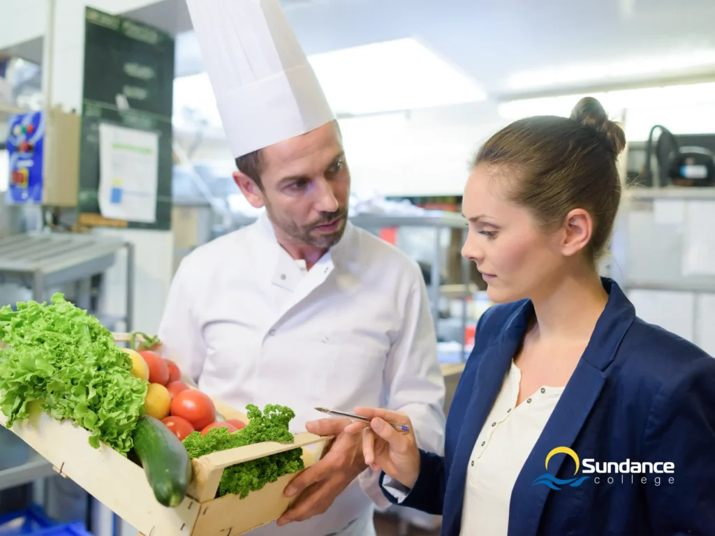 manager inspecting vegetables in the kitchen