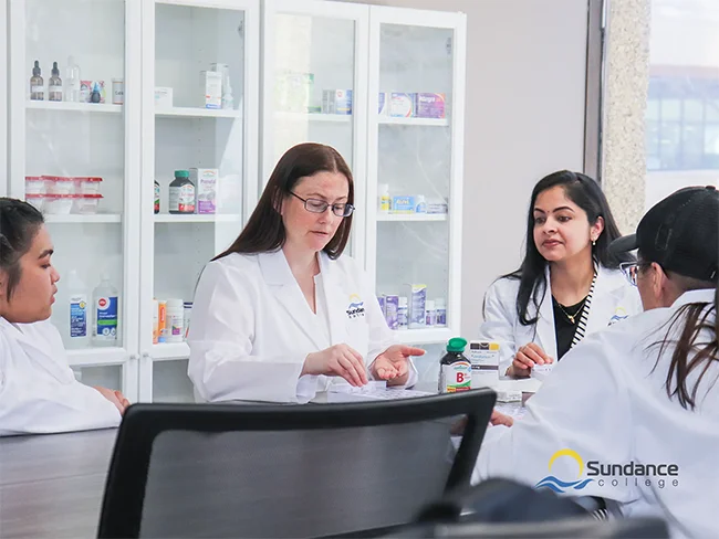 Pharmacy assistant instructor teaching students in the Sundance College on-campus pharmacy lab.