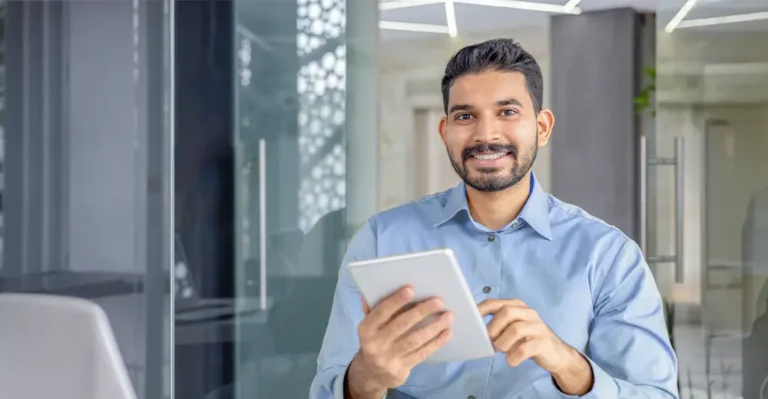 A tech expert demonstrating his knowledge to two colleagues in an office, highlighting the demand for technological expertise.