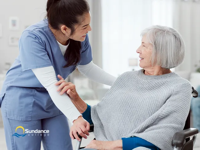 A personal support worker helping a patient.