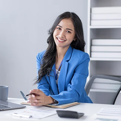 An accounting assistant sitting at a desk.