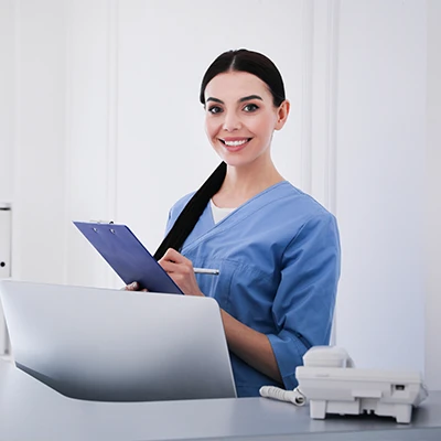 A medical office administrator at a computer.