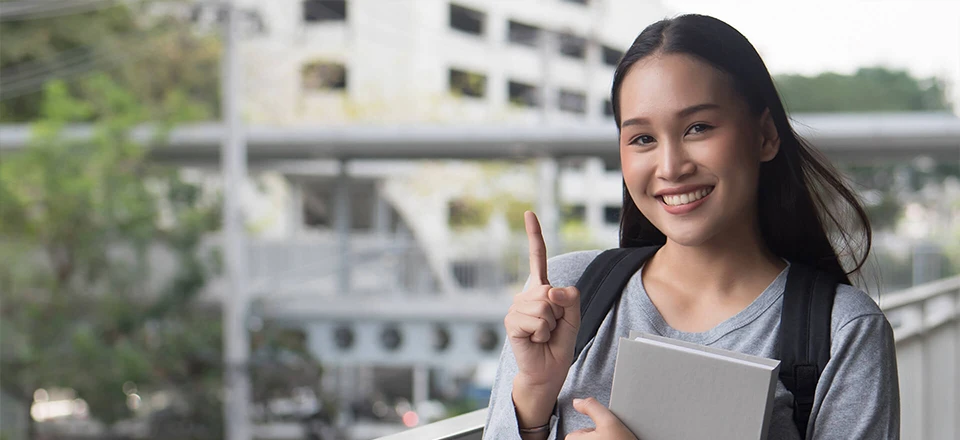 a woman standing outside with laptop