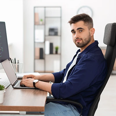 A technology professional working on a laptop.