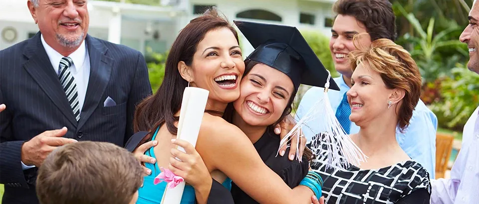 A woman celebrating graduation with her family.