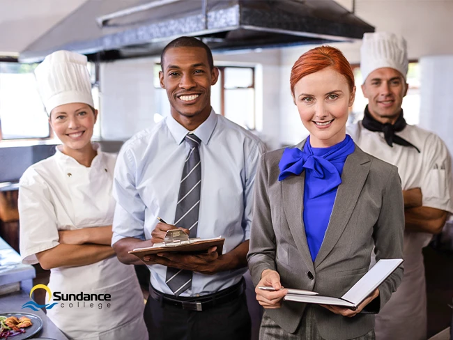 A group of hotel staff standing in the kitchen, exemplifying one of the biggest sectors in the hospitality industry in Canada.