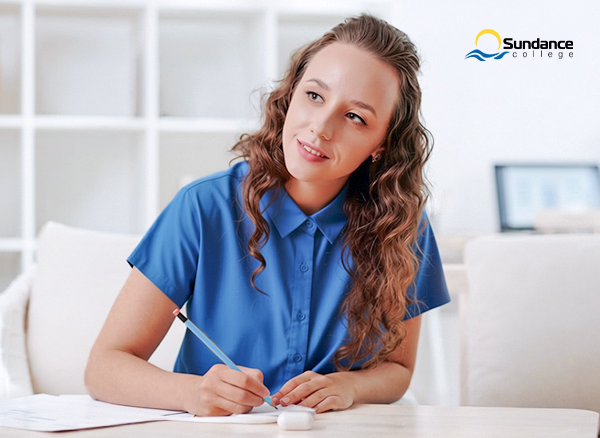 A young woman reviewing interview notes and practicing answers using the STAR technique.