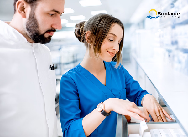 A pharmacy assistant checking medication inventory inside a pharmacy.
