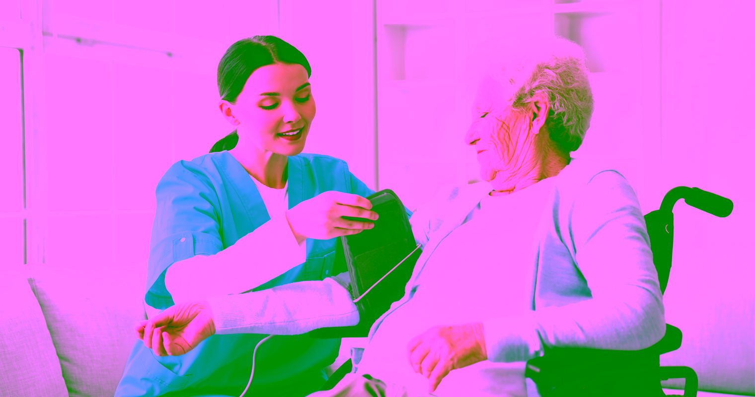 Home Support Worker assisting an older adult with a routine health checkup in a home setting.